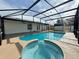 Screened-in pool and jacuzzi with view of backyard and home at 3055 Kirkland St, Deltona, FL 32738