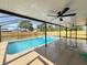 Relaxing backyard pool with a screened-in lanai and fan, perfect for outdoor entertainment at 3055 Kirkland St, Deltona, FL 32738