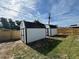 Two white sheds with black trim offer ample backyard storage solutions at 3055 Kirkland St, Deltona, FL 32738