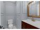 Elegant powder room featuring wainscoting, gold mirror, and stylish fixtures at 315 Desoto Cir, Orlando, FL 32804