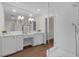Bright bathroom with a glass shower, featuring double sinks and vanity space at 315 Desoto Cir, Orlando, FL 32804