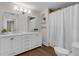 Bright bathroom features a double vanity, decorative mirror, and shower/tub combo with white tile at 315 Desoto Cir, Orlando, FL 32804