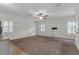 Bright bedroom featuring neutral walls, plush carpeting, and natural light from multiple shuttered windows at 315 Desoto Cir, Orlando, FL 32804