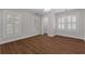 Well-lit bedroom with hardwood floors features three large windows and modern lighting at 315 Desoto Cir, Orlando, FL 32804