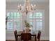 Dining room features a gorgeous chandelier and large windows with plantation shutters at 315 Desoto Cir, Orlando, FL 32804