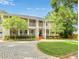 Inviting two-story home featuring a brick driveway, manicured lawn, and covered porch at 315 Desoto Cir, Orlando, FL 32804