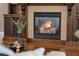 A cozy fireplace framed by custom wood cabinetry with glass door accents makes this home inviting at 315 Desoto Cir, Orlando, FL 32804