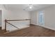 Bright hallway features wood flooring, white railings, and a French door leading to a balcony at 315 Desoto Cir, Orlando, FL 32804