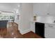 Elegant kitchen featuring white cabinetry, black appliances, and hardwood floors at 315 Desoto Cir, Orlando, FL 32804