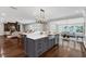 Open concept kitchen with stainless steel appliances and a large island that flows into the living room and dining area at 315 Desoto Cir, Orlando, FL 32804