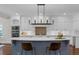 Bright kitchen features white cabinets, stainless steel appliances, large island, and modern lighting at 315 Desoto Cir, Orlando, FL 32804