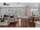 Spacious living room with wood floors, and french doors leading to the screened in porch at 315 Desoto Cir, Orlando, FL 32804