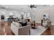 Spacious living room with hardwood floors, modern furnishings, and an open view to the kitchen at 315 Desoto Cir, Orlando, FL 32804