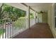 Covered porch with brick flooring, offering a relaxing outdoor space with neighborhood views at 315 Desoto Cir, Orlando, FL 32804
