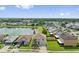 Aerial view of a home near a serene lake, surrounded by lush greenery and other houses at 328 Fairfield Dr, Sanford, FL 32771