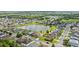 Scenic aerial view of a residential community surrounding a serene pond and lush greenery at 328 Fairfield Dr, Sanford, FL 32771