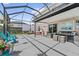 Spacious screened-in patio with hot tub, outdoor furniture, and lush greenery at 328 Fairfield Dr, Sanford, FL 32771