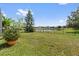 A spacious backyard with lush grass and a black metal fence overlooking a tranquil lake at 328 Fairfield Dr, Sanford, FL 32771
