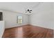 Bright bedroom featuring wood floors, a ceiling fan, and a window providing natural light at 328 Fairfield Dr, Sanford, FL 32771