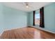 Empty bedroom with light blue walls, a ceiling fan, and hardwood flooring at 328 Fairfield Dr, Sanford, FL 32771