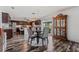Open dining area adjacent to kitchen featuring wood-look floors, four chairs, and built in china cabinet at 328 Fairfield Dr, Sanford, FL 32771