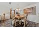 Bright dining room features wood-look floors, large windows, stylish light fixture and wall art at 328 Fairfield Dr, Sanford, FL 32771