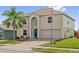 Charming two-story home featuring a well-maintained lawn, a large palm tree, and a two-car garage at 328 Fairfield Dr, Sanford, FL 32771