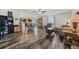 Open-concept living space with wood flooring, bright lighting, and connected dining and kitchen areas at 328 Fairfield Dr, Sanford, FL 32771