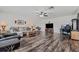 Spacious living room features wood-look floors, ceiling fan, and ample seating at 328 Fairfield Dr, Sanford, FL 32771