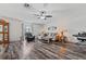 Bright living room featuring wood-look floors, ceiling fan, and ample seating with many lights at 328 Fairfield Dr, Sanford, FL 32771