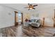 Comfortable living room features wood-look floors, a ceiling fan, a plush sofa, and curtains at 328 Fairfield Dr, Sanford, FL 32771