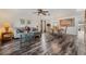 Spacious living room and dining room with wood-look floors, ceiling fan, and ample natural light at 328 Fairfield Dr, Sanford, FL 32771