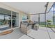 Covered patio featuring neutral outdoor furniture and sliding glass doors to the home's interior at 328 Fairfield Dr, Sanford, FL 32771