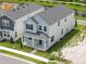 Aerial view of a modern two-story home, showcasing the roof, landscaping, and proximity to a pond at 353 Belmond Dr, Debary, FL 32713