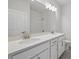 Bathroom with a double sink vanity, framed mirror, and a shower with glass door at 353 Belmond Dr, Debary, FL 32713