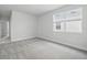 Bright bedroom with neutral carpet, a large window, and fresh, white paint at 353 Belmond Dr, Debary, FL 32713