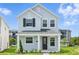 Charming two-story home featuring light blue siding, black shutters, and a welcoming front porch at 353 Belmond Dr, Debary, FL 32713