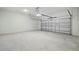 Spacious garage with smooth concrete flooring and a white door at 353 Belmond Dr, Debary, FL 32713