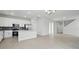 Bright, open-concept kitchen featuring white cabinets, stainless steel appliances, and tile flooring at 353 Belmond Dr, Debary, FL 32713