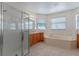 Spacious bathroom featuring a glass shower, soaking tub, and double sink vanity at 3774 Eagle Isle Cir, Kissimmee, FL 34746