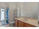 Bathroom with sink, large mirror, and tub/shower featuring a curtain, offering a practical and clean space at 3774 Eagle Isle Cir, Kissimmee, FL 34746