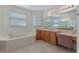 Bright bathroom featuring a soaking tub, dual sinks, vanity and plenty of natural light at 3774 Eagle Isle Cir, Kissimmee, FL 34746