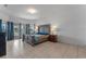 Bright bedroom featuring a sizable bed, tile floors and a nightstand with a lamp at 3774 Eagle Isle Cir, Kissimmee, FL 34746