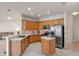 Well-equipped kitchen features wooden cabinets, stainless steel appliances and an island at 3774 Eagle Isle Cir, Kissimmee, FL 34746