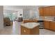 Open kitchen featuring stainless appliances, a large island and a view into the living room at 3774 Eagle Isle Cir, Kissimmee, FL 34746