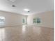 Spacious living room featuring neutral walls, tile flooring, and large windows providing ample natural light at 3774 Eagle Isle Cir, Kissimmee, FL 34746