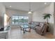 Comfortable living room with tile flooring, large window view and cozy seating area at 3774 Eagle Isle Cir, Kissimmee, FL 34746