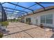 Expansive screened-in lanai with brick patio, ideal for outdoor entertaining and relaxing with views at 3774 Eagle Isle Cir, Kissimmee, FL 34746
