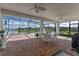 Screened patio featuring tile floor, ceiling fans, and expansive lake views, perfect for relaxing outdoors at 3774 Eagle Isle Cir, Kissimmee, FL 34746