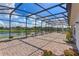 Expansive screened patio with a peaceful lake view, perfect for entertaining or relaxing at 3774 Eagle Isle Cir, Kissimmee, FL 34746